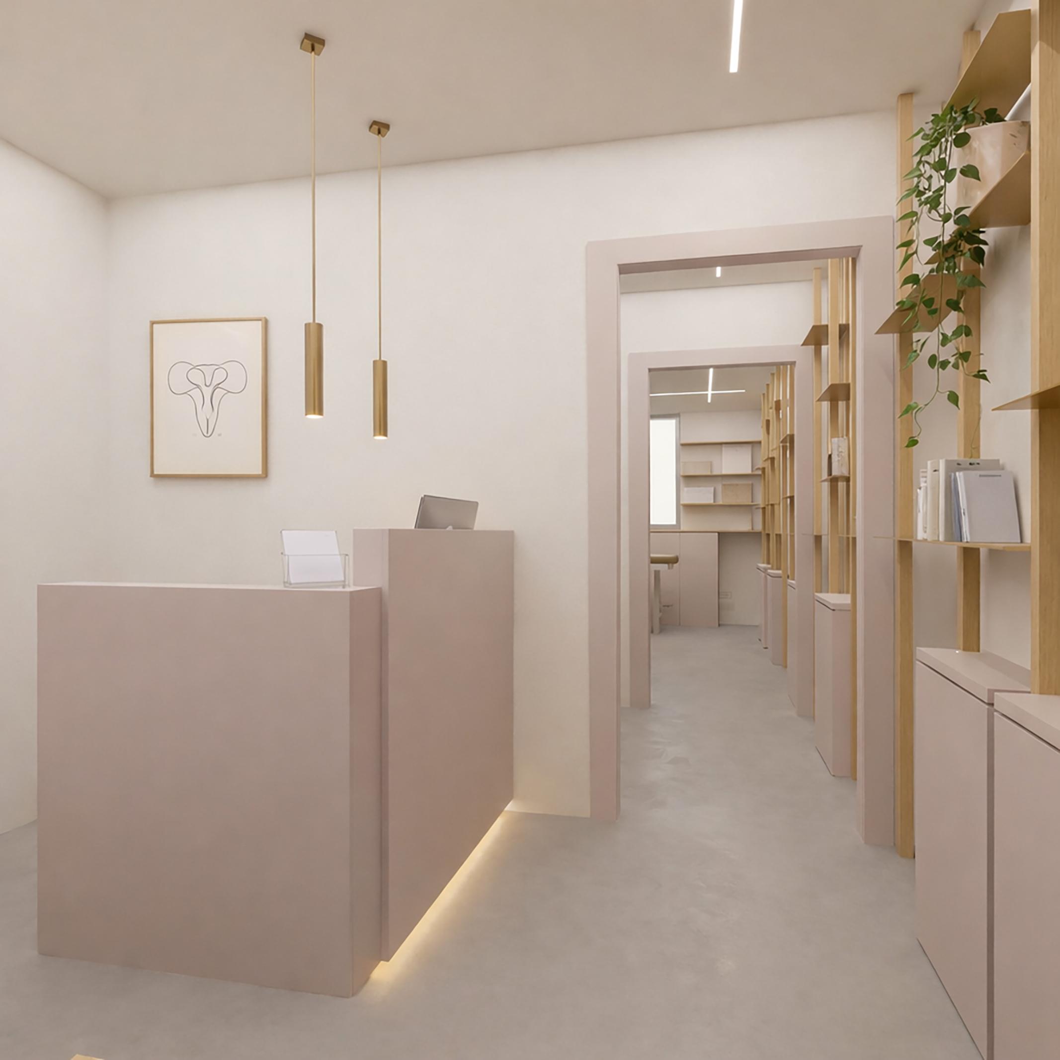 Studio I.A., ingresso con banco reception, arredi su misura e illuminazione sospesa